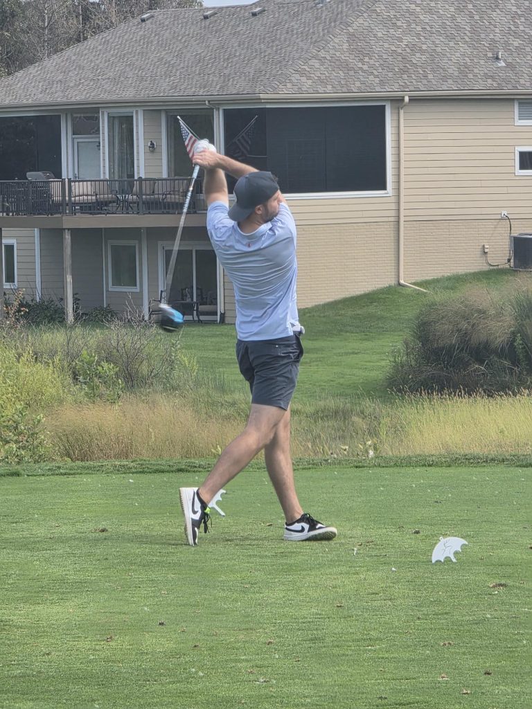 Community: Ryan Conway of JE Dunn tees off from the Players Club green