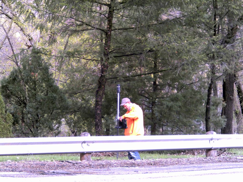 GEOPAK: A surveyor using a prism pole to code descriptions of features along a highway in GEOPAK transportation design software.