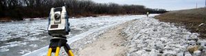 Glossary of Surveying Terms page photo of survey work along river